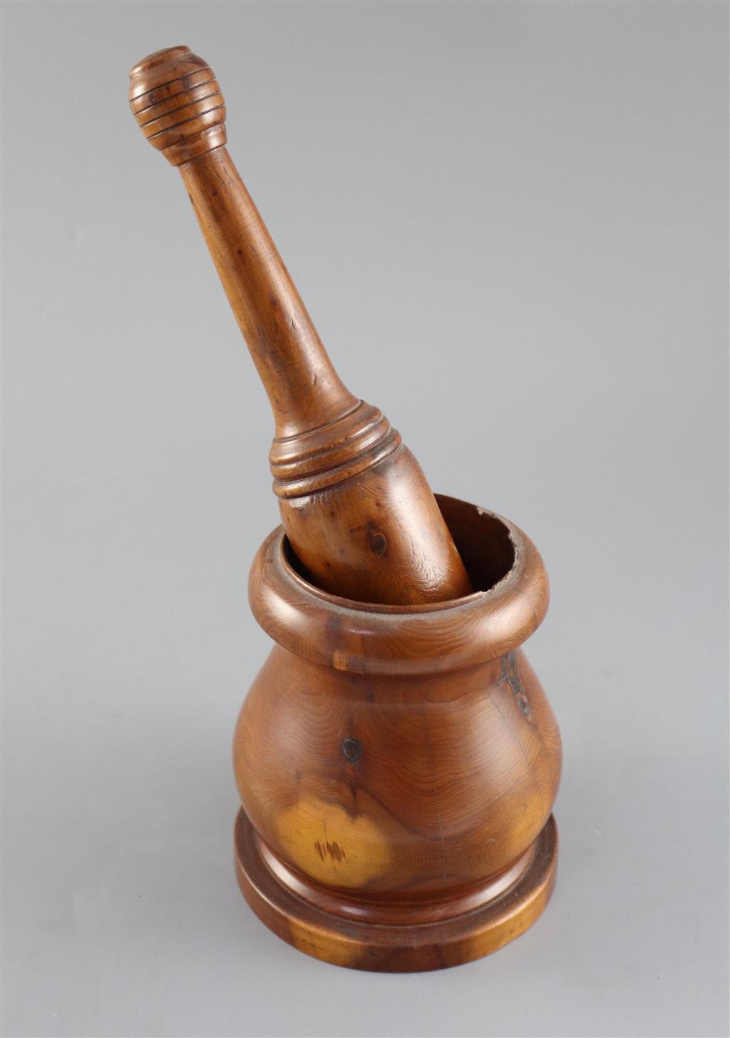 A late 18th / early 19th century turned yew wood pestle and mortar, pestle 9in. mortar height 5in.